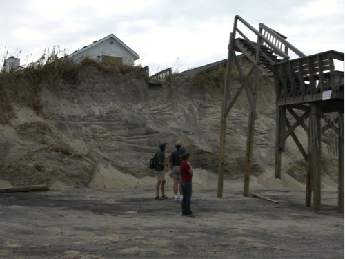 House separated from its beachfront stairs by dune erosion. See caption for more.