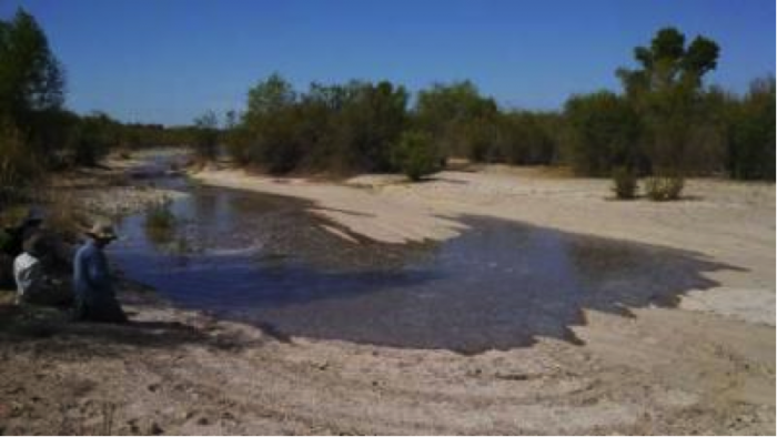 image of Flow front of the released water. Tiny stream over desert ground
