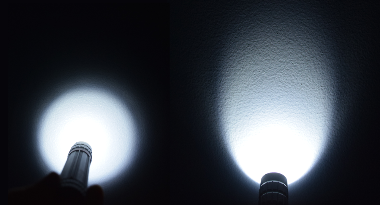 two flashlights shining on a wall